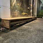 店舗のガラス面に沿って製作された、天然木のディスプレイ用デッキスペース